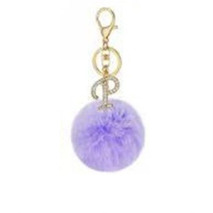 Detailed view of purple faux fur pom pom keychain with gold rhinestone letter P charm