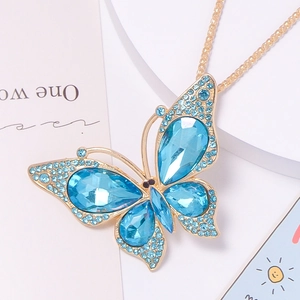 Detailed macro view of butterfly keychain with blue rhinestones and gold alloy base