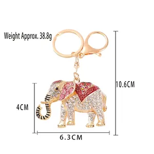 Sparkly crystal elephant keychain in gold finish with pink rhinestones and enamel flower
