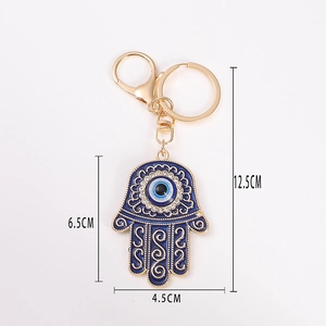 Portachiavi Mano di Fatima dorata con smalto blu e cristalli scintillanti decorativi