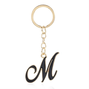 Letter M keychain with black enamel finish and golden metal keyring for bags