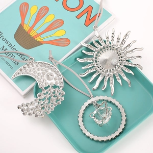 Set of three silver moon and sun Christmas ornaments with rhinestones and grey hanging cords