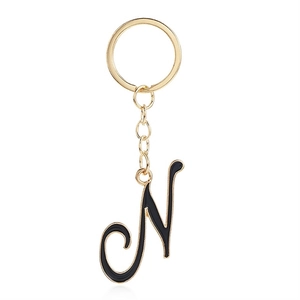 Letter N keychain with black enamel gold finish pendant on a polished metal ring