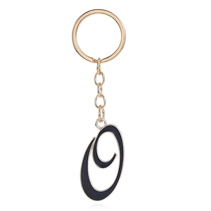 Letter O keychain with black enamel finish and gold plated alloy rim on white background