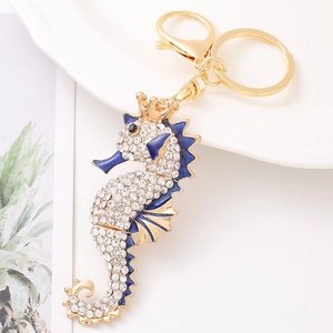 Golden seahorse keychain with sparkling rhinestones and crown detail on white background