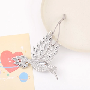 Intricate silver hummingbird ornament with sparkling rhinestones and grey suede cord