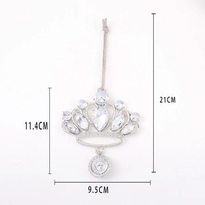 Detailed view of silver crown ornament with clear gems showing 11.4cm height scale