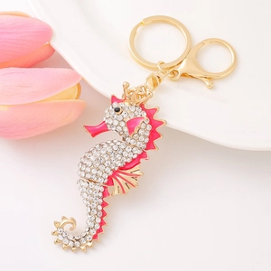 Close-up of sparkling seahorse keychain with pink enamel, rhinestones and lobster clasp