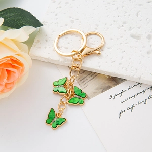 Elegant gold keychain with three green gradient butterfly pendants and sparkling crystals