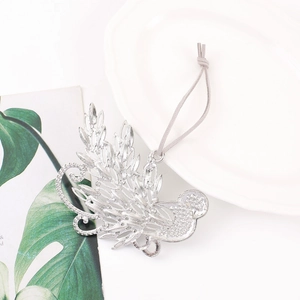 Close-up of hummingbird metal ornament with sparkling rhinestones and grey cord