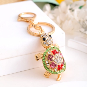 Macro shot of colorful rhinestone turtle keychain with gold metal base and spring clasp