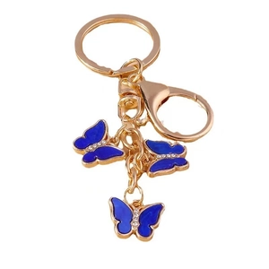 Golden butterfly keychain featuring three blue enamel butterflies with sparkling rhinestones