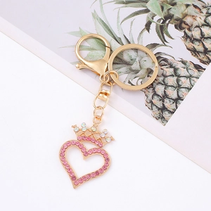 Detail of heart crown keychain with pink rhinestones and lobster clasp on bag charm