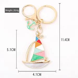 Colorful metal sailboat keychain with crystals and small anchor charm for women's handbag
