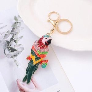 Detailed macro view of enamel parrot keychain with vibrant rhinestones and golden clasp