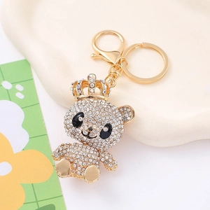 Macro shot of crown bear keychain with white rhinestones and golden lobster clasp