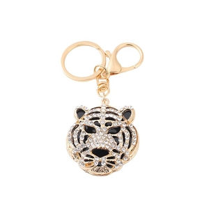Detail of tiger head keychain with sparkling rhinestones and golden lobster clasp