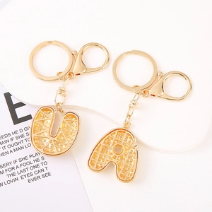 Golden alphabet letter keychains with elegant inlaid pearls and lobster clasp clips