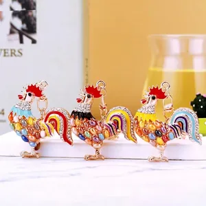 Colorful rooster keychain with rhinestones and opal stones on a golden alloy metal base