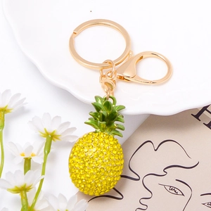 Detailed view of yellow rhinestone pineapple keychain with golden ring and lobster clasp