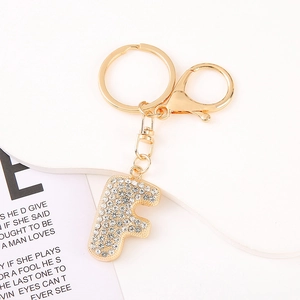 Detailed macro view of crystal-encrusted letter F keychain with golden zinc alloy lobster clasp