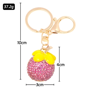 Detail of mangosteen rhinestone keychain with size 4x3cm and weight 37.2g on white backdrop