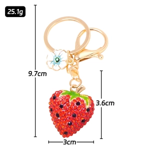 Detailed size view of rhinestone strawberry keychain with 9.7cm total length and weight