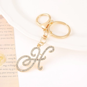Detailed close-up of golden letter K keychain with sparkling rhinestones and lobster clasp