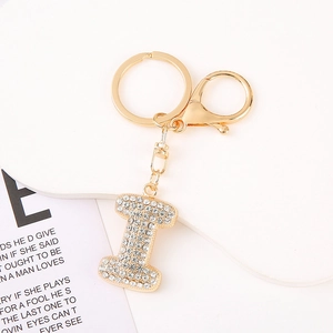 Detail of crystal letter I keychain with gold plating and rhinestones on white base