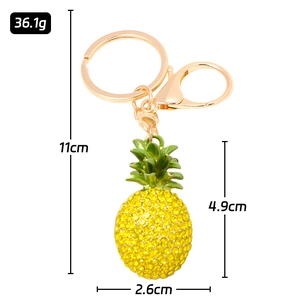 Detailed view of pineapple keychain with yellow rhinestones and golden lobster clasp