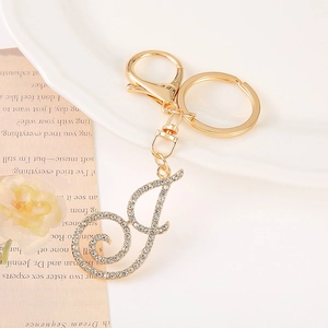 Detail of gold-plated letter J keychain with sparkling crystal rhinestones and lobster clasp