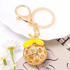 Cute golden zinc alloy keychain with hollow clover ball and purple rhinestones