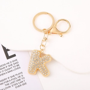 Macro shot of letter K gold keychain with sparkling rhinestones and lobster clasp