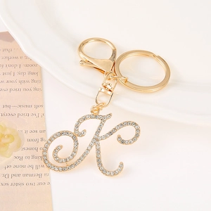 Detailed view of a gold-plated letter K keychain with inlaid rhinestones and lobster clasp