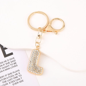 Detail of crystal letter L keychain with sparkling rhinestones and golden hardware