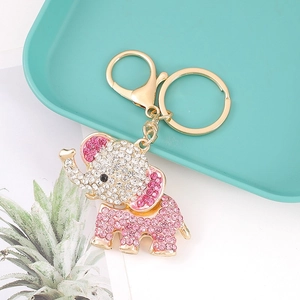 Detailed close-up of elephant keychain featuring pink rhinestones on blue tray