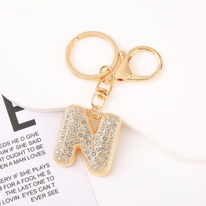 Macro shot of letter N keychain with sparkling crystals and gold lobster clasp