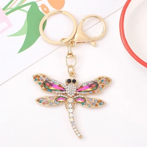 Golden dragonfly keychain with colorful rhinestones and crystals on white background