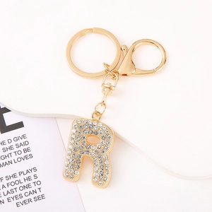 Detail shot of golden letter R keychain with sparkling rhinestones and lobster clasp