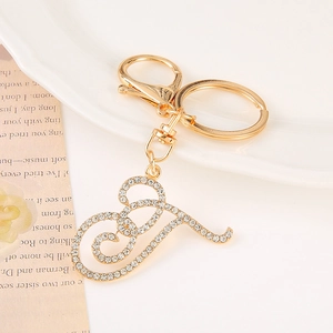 Detail of a gold letter J keychain with sparkling rhinestones and a lobster clasp