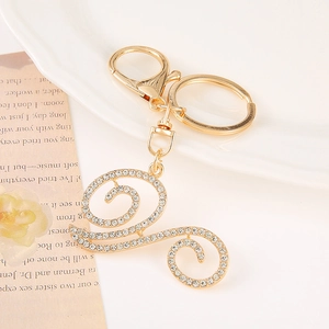 Detail of a golden alphabet keychain with sparkling rhinestones and lobster clasp