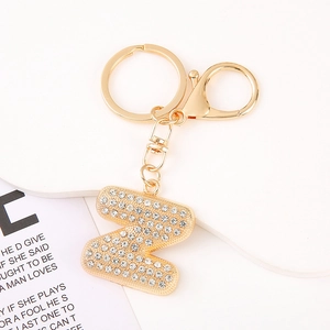 Macro shot of gold letter Z keychain with sparkling rhinestones and spring hook