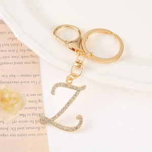 Detailed macro view of a gold-toned zinc alloy letter Z keychain with white rhinestones