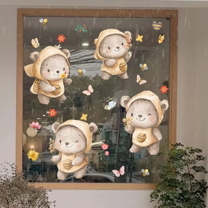 Detailed watercolor bear stickers with bees and flowers applied on a glass window surface