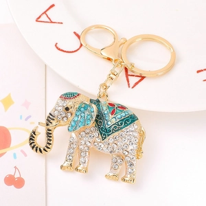 Detailed close-up of crown elephant keychain with blue rhinestones and enamel patterns