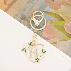 Gold zinc alloy heart keychain with crystal letter H and pink enamel floral details