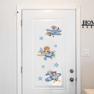 Detailed view of watercolor animals flying airplanes stickers on a white nursery room door