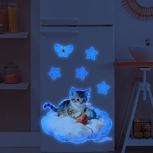 Glow-in-the-dark blue cat on cloud wall sticker applied on white fridge surface
