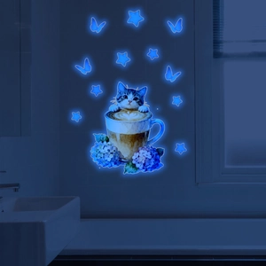 Glow-in-the-dark wall stickers with cat in cup, butterflies and stars in blue neon light