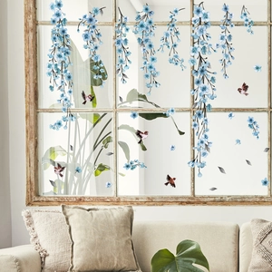 Blue ink flowers and brown birds static window stickers displayed on a white glass frame